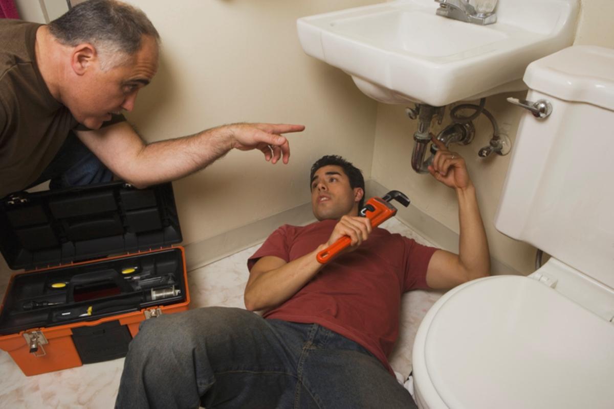 a plumber working on the sink