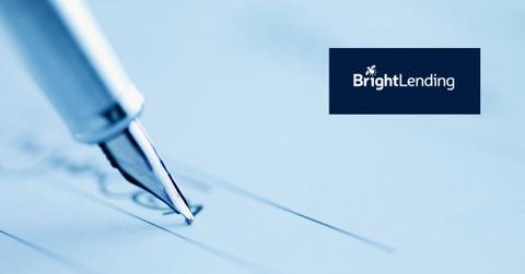 A pen being used to sign a contract and the Bright Lending logo