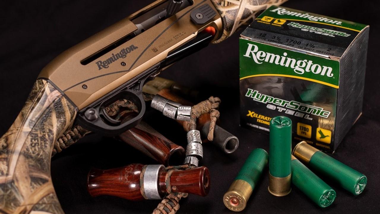 A Remington hunting rifle sits beside a box of ammunition.