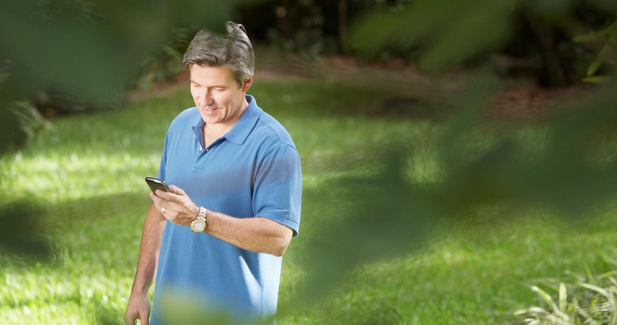 older man looking at phone