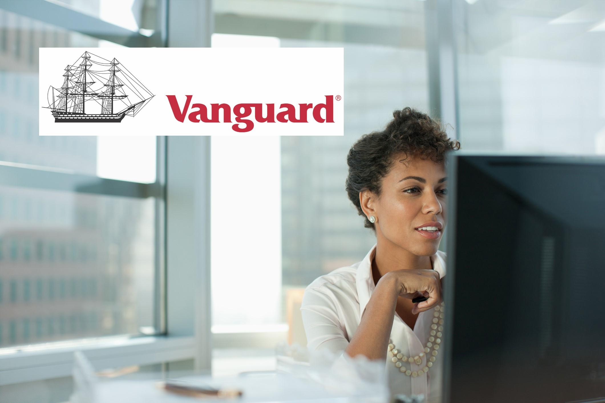 Vanguard logo over investor doing research on VOO VTI ETFs