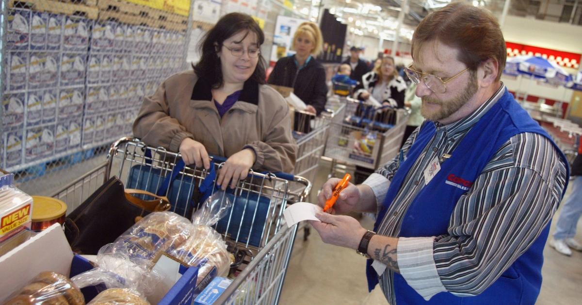 A Costco worker checking receipts