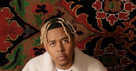 Cordae wearing a light beige jacket.