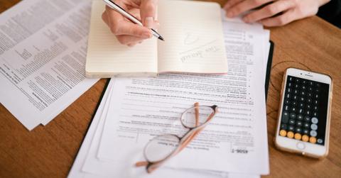 A person filling out tax forms