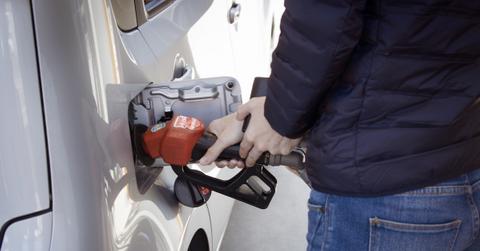 A man putting gas in a vehicle