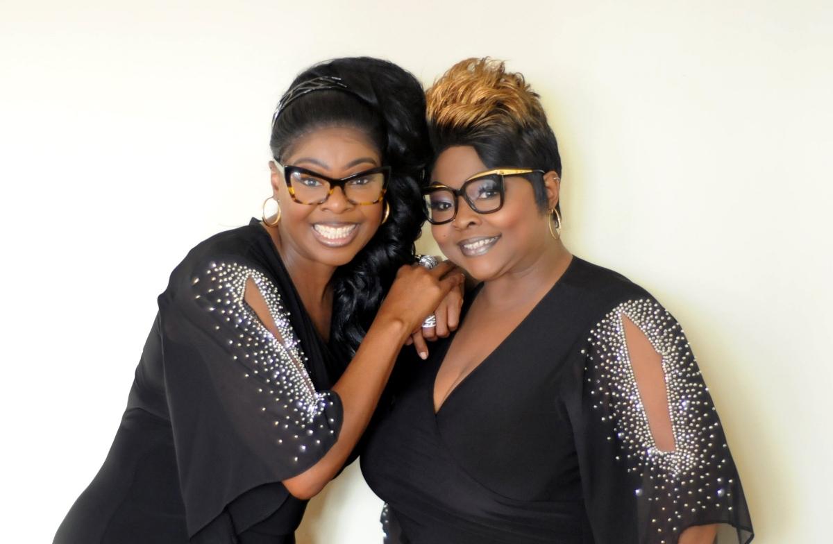 Diamond and Silk pose together in black and silver tops.