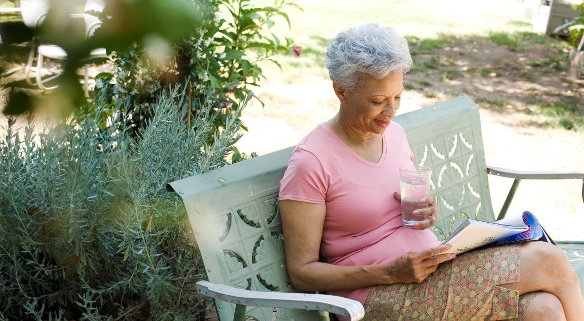 elderly person reading outside