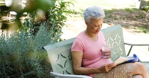 elderly person reading outside