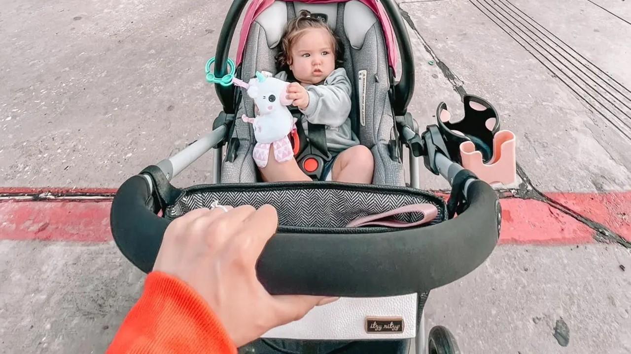 A woman pushing a baby in a stroller in a Target 