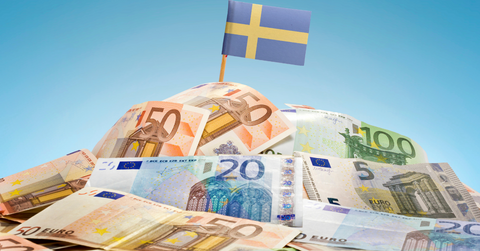 A pile of Swedish bills with a flag on top