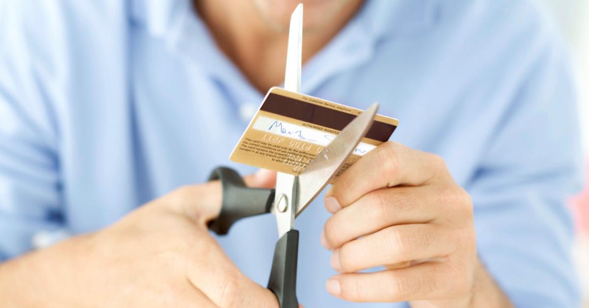 Person cutting credit card