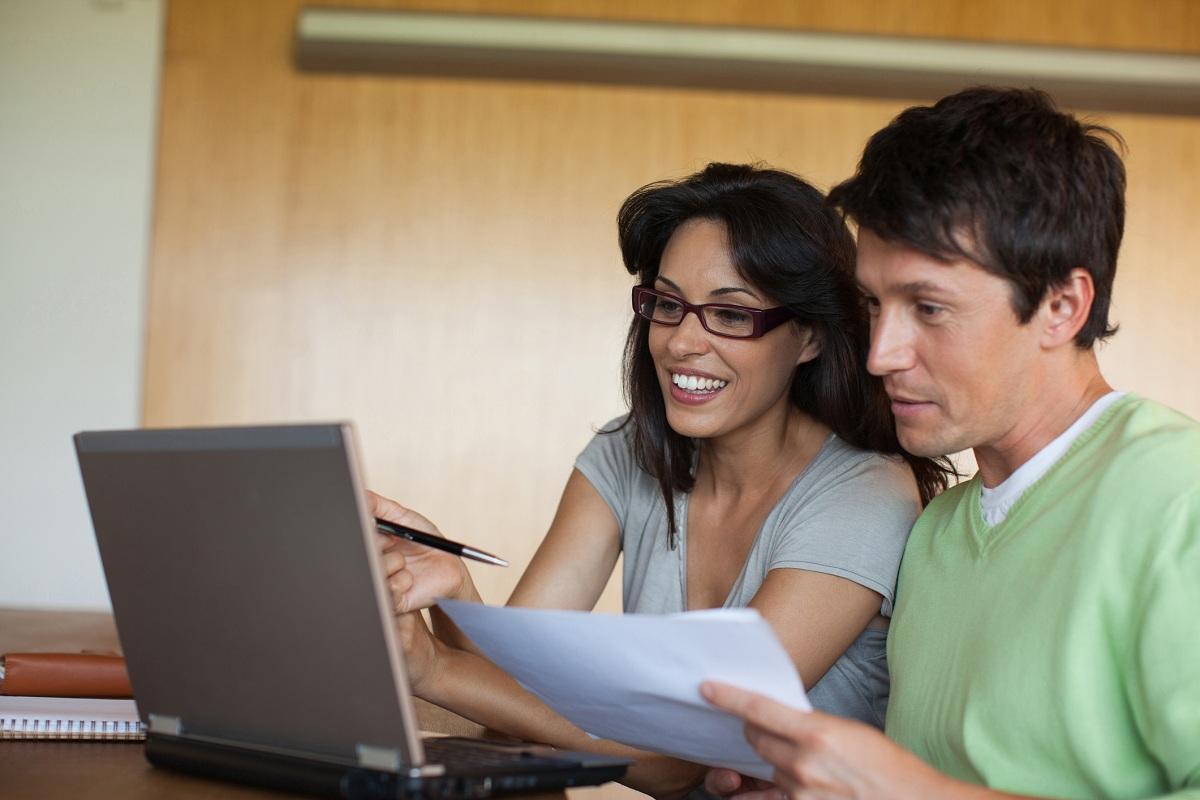 Couple paying bills on laptop together