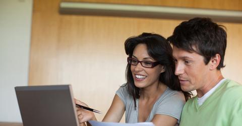 Couple paying bills on laptop together
