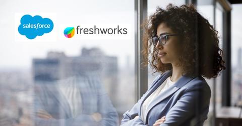 Woman looking out a window with Freshworks and Salesforce logos