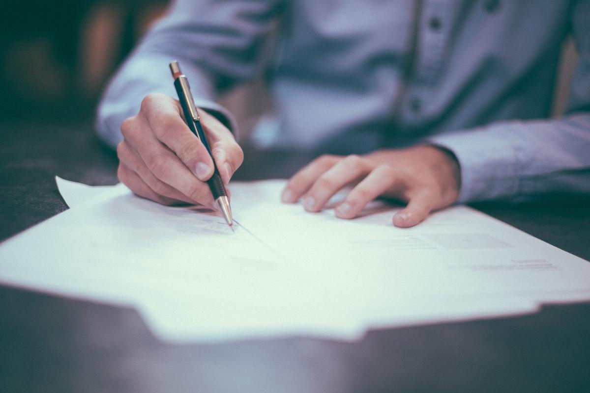 A man signing loan documents