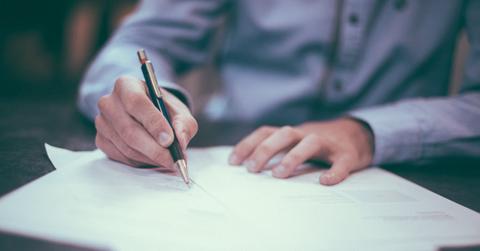 A man signing loan documents