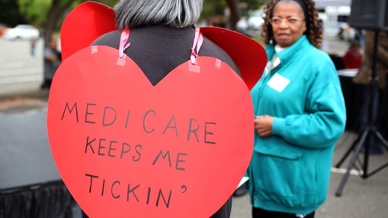 Woman wearing a sign during a Medicare rally