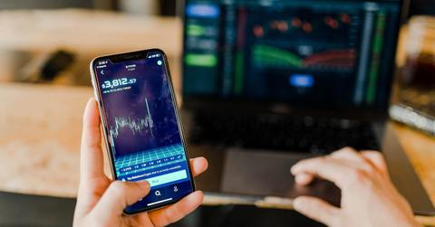 Person using a laptop and smartphone