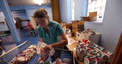 A woman prepares food baskets