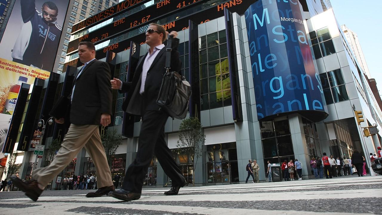 Men walking by Morgan Stanley headquarters