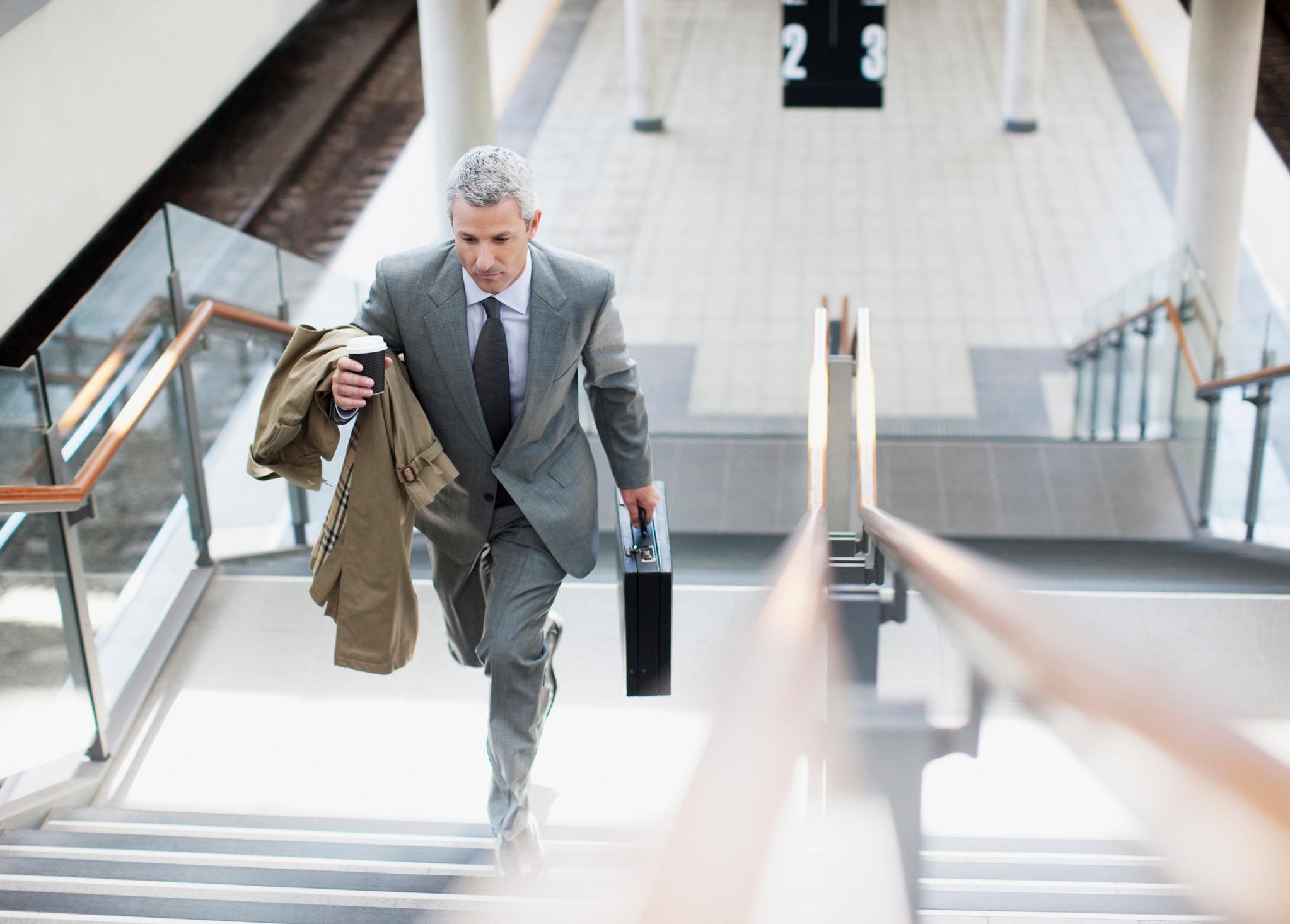 A businessperson walking up stairs