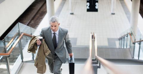A businessperson walking up stairs