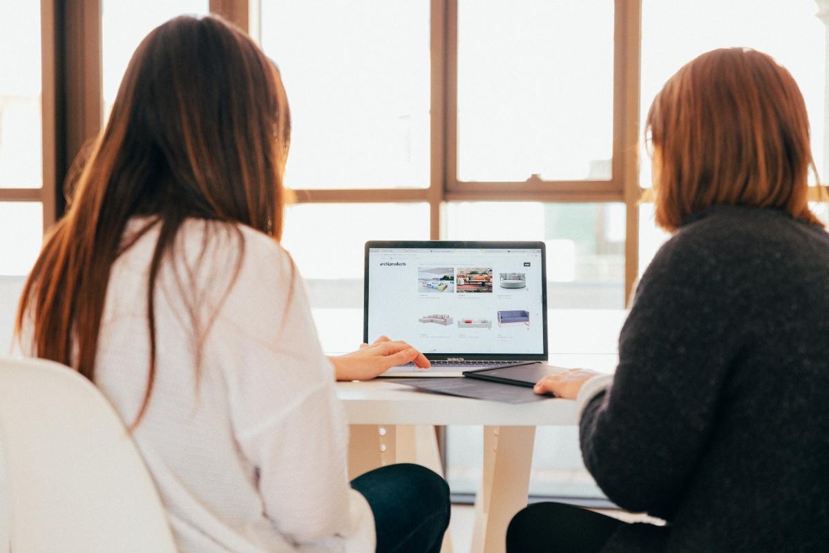 Two women working on website