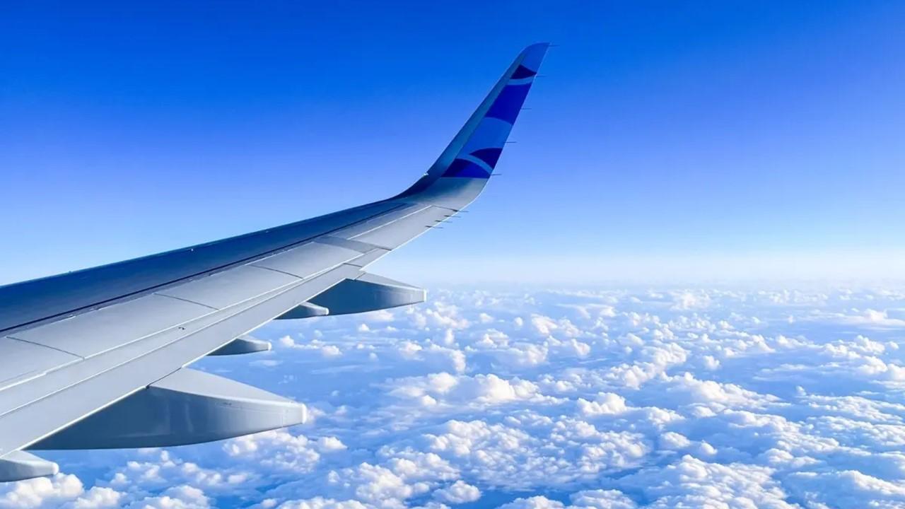 The wing of a JetBlue plane in the sky