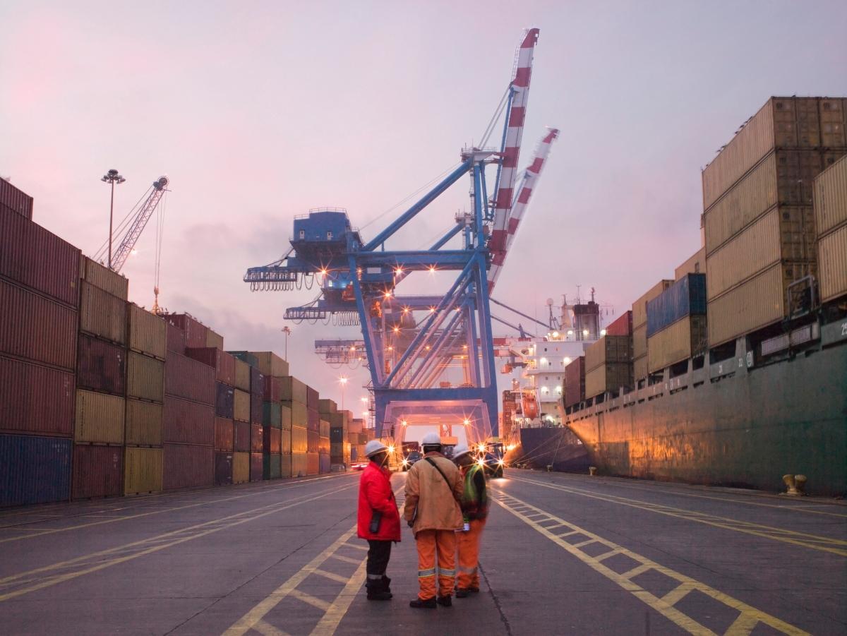 Shipping containers getting unloaded at a port