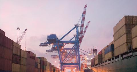 Shipping containers getting unloaded at a port