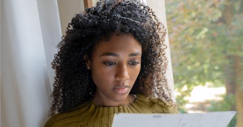 A woman looking at layoff paperwork