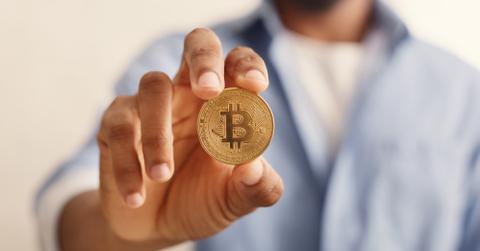 uploads///golden bitcoin in african american man hand closeup