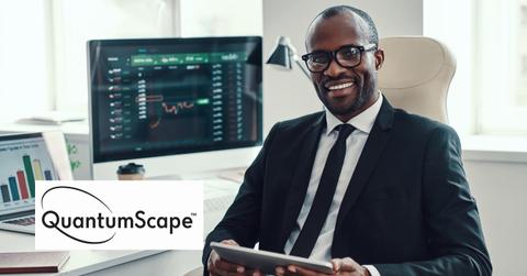 Investor holding a tablet and QuantumScape logo