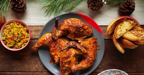 Image of roasted chicken on plate surrounded by sides