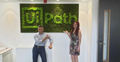 Two person posing with UiPath logo