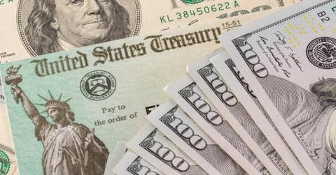 Stimulus check and $100 bills