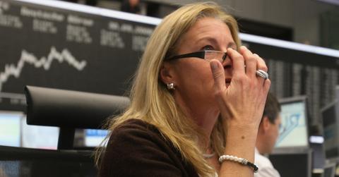 A worried trader looks on as stocks correct