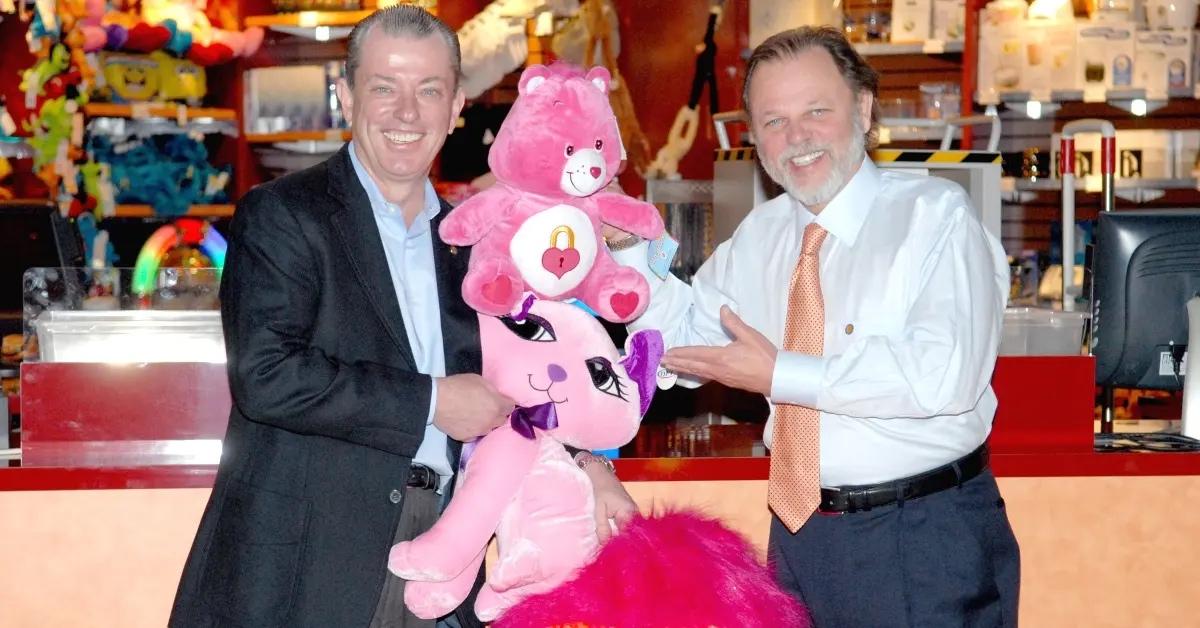 David Corriveau and James Corley holding a plush toy at a Dave & Buster's.