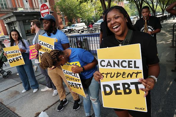 Student loan borrowers celebrating Biden delaying student loan repayment