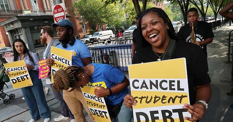 Student loan borrowers celebrating Biden delaying student loan repayment