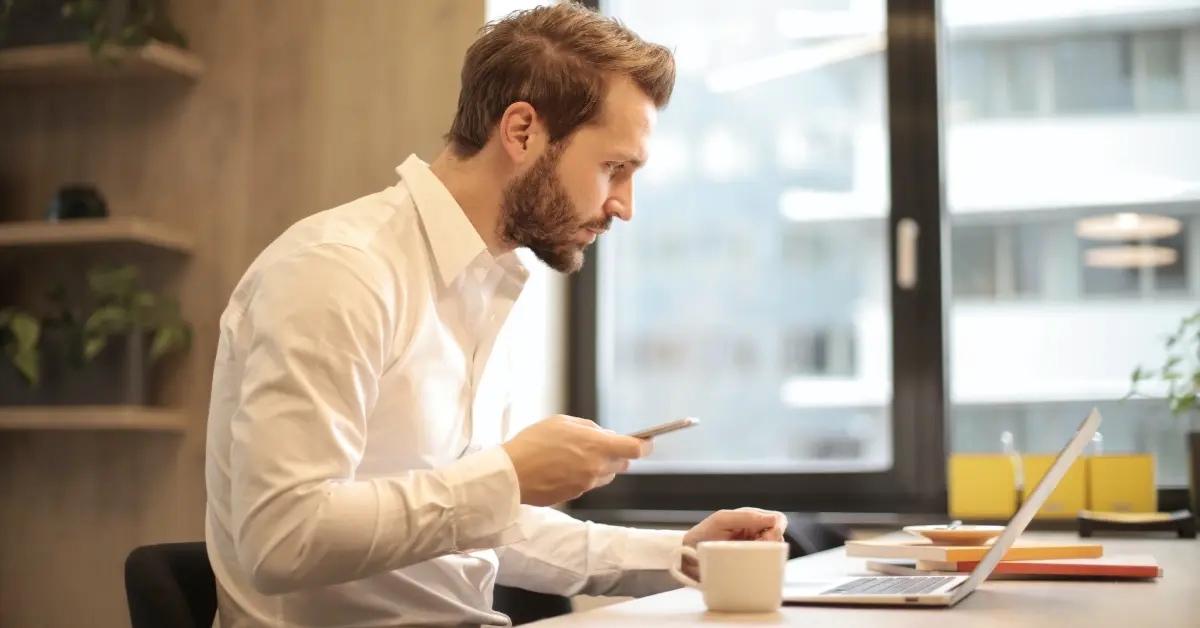 A businessman calculating his SUI taxes on his computer.