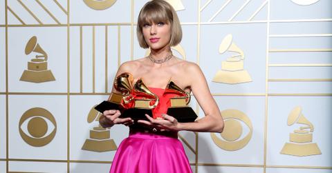 Taylor Swift holding Grammy Awards.