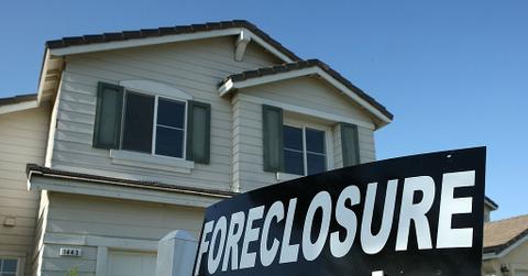 A house and foreclosure sign