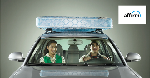 Couple driving a car with a mattress on top and Affirm's logo