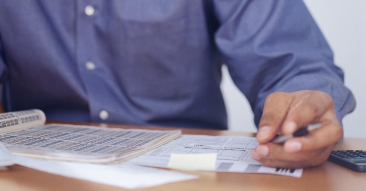 A man looking at tax documents.