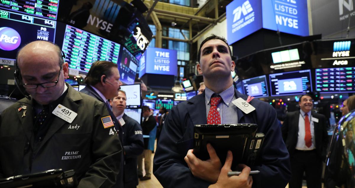 Trader looks on  as a stock lists on NYSE