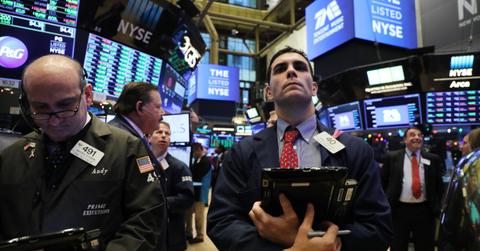 Trader looks on  as a stock lists on NYSE