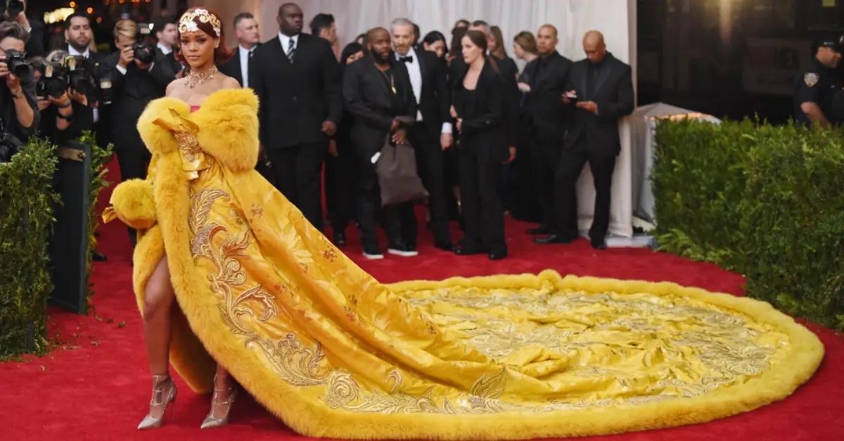 Rihanna in a yellow dress on the red carpet at the 2015 Met Gala.