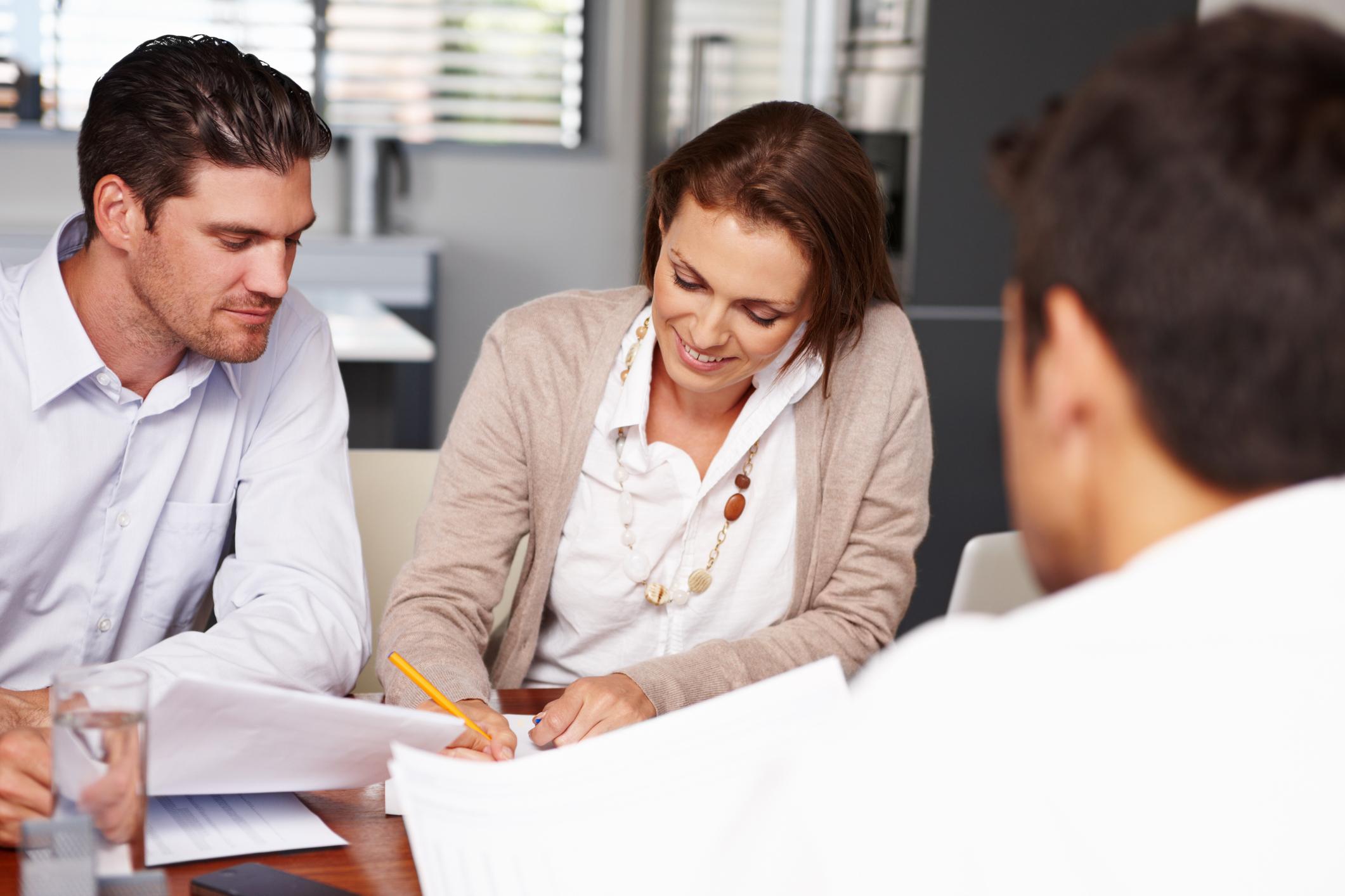 People filling out bank account paperwork