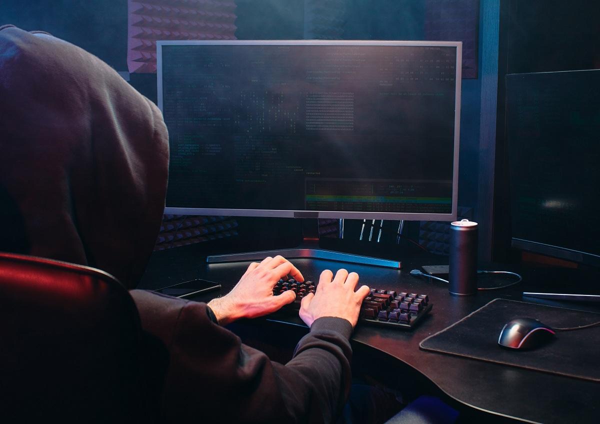 Person in a black hoodie using a computer